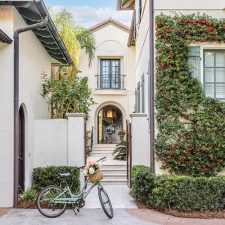 Front of big white house with a bike in front